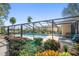 Inviting screened pool area with lush landscaping at 2112 Gulf View Blvd, Dunedin, FL 34698