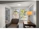 Bright sunroom features a comfy chair and large windows offering ample natural light at 2112 Gulf View Blvd, Dunedin, FL 34698