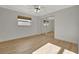 Bedroom with mirrored closet doors and light wood floors at 2851 Hardee Dr, Sarasota, FL 34231