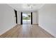 Bright bedroom with wood-look floors and sliding glass doors leading to the pool at 2851 Hardee Dr, Sarasota, FL 34231