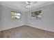 Bright bedroom with two windows and ceiling fan at 2851 Hardee Dr, Sarasota, FL 34231