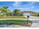 House with tile roof, palm trees, and a well-manicured lawn at 2851 Hardee Dr, Sarasota, FL 34231