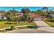 Single-story home with tile roof, landscaped yard, and driveway at 2851 Hardee Dr, Sarasota, FL 34231