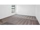 Spacious bedroom with gray carpeting and large window at 29603 Fedora Cir, Brooksville, FL 34602