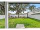 Spacious backyard with lush lawn, privacy fence, and mature trees at 320 W Jean St, Tampa, FL 33604