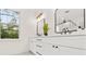 Bright bathroom with double vanity and window at 320 W Jean St, Tampa, FL 33604