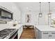 White kitchen with stainless steel appliances and breakfast bar at 320 W Jean St, Tampa, FL 33604