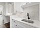 Bright laundry room with white cabinets and quartz countertops at 320 W Jean St, Tampa, FL 33604