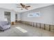 A bedroom with grey walls, tiled floors, and a ceiling fan at 4000 14Th Ne St, St Petersburg, FL 33703