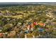 Aerial view of a luxury home featuring a private pool, manicured landscaping, and elegant design at 403 Weeburn Rd, Temple Terrace, FL 33617