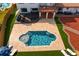 Aerial view of a backyard featuring a custom pool design, lush landscaping, and an inviting outdoor living space at 403 Weeburn Rd, Temple Terrace, FL 33617