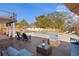An inviting backyard features a wooden deck with pool and lounge furniture for relaxing outdoors at 403 Weeburn Rd, Temple Terrace, FL 33617