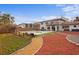 A spacious backyard featuring a pool, patio, and lush landscaping, perfect for outdoor enjoyment at 403 Weeburn Rd, Temple Terrace, FL 33617