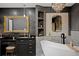 Stunning bathroom featuring a soaking tub, chandelier, and black vanity at 403 Weeburn Rd, Temple Terrace, FL 33617