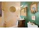 Elegant powder room featuring decorative gold mirrors and a unique vanity with stone countertop at 403 Weeburn Rd, Temple Terrace, FL 33617
