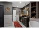 Elegant bathroom with marble floors, framed mirrors, and black vanity at 403 Weeburn Rd, Temple Terrace, FL 33617