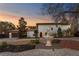 Stunning home features a lovely front yard, beautiful landscaping, and a charming water fountain at 403 Weeburn Rd, Temple Terrace, FL 33617