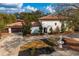 Aerial view of a two-story stucco home with tile roof, mature trees, circular drive, fountain, and lush landscaping at 403 Weeburn Rd, Temple Terrace, FL 33617