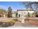 Two-story home featuring stucco exterior, terra cotta roof, mature trees, fountain, and manicured landscaping at 403 Weeburn Rd, Temple Terrace, FL 33617