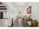 Elegant hallway with tiled floors, arched doorways, art, chandelier lighting and decorative accents throughout at 403 Weeburn Rd, Temple Terrace, FL 33617