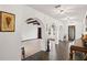 Hallway featuring tiled floors, arched doorways, art, chandelier lighting and decorative accents throughout at 403 Weeburn Rd, Temple Terrace, FL 33617