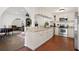 Open kitchen featuring white cabinetry, granite countertops, and stainless steel appliances at 403 Weeburn Rd, Temple Terrace, FL 33617