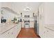 Bright kitchen featuring white cabinets, granite countertops, and stainless steel appliances at 403 Weeburn Rd, Temple Terrace, FL 33617