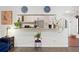 Eat-in kitchen showcasing breakfast bar with granite countertops and open layout at 403 Weeburn Rd, Temple Terrace, FL 33617