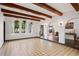 Bright living room showcasing wood beam ceiling, decorative tile floors and arched doorways at 403 Weeburn Rd, Temple Terrace, FL 33617