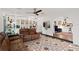 Open-concept living room boasting decorative tile flooring and built-in shelving; seamlessly connects living spaces at 403 Weeburn Rd, Temple Terrace, FL 33617