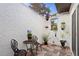 Charming outdoor patio area with decorative tile flooring, iron furniture, and potted plants for relaxed living at 403 Weeburn Rd, Temple Terrace, FL 33617