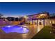 Back of house view at dusk featuring a beautiful pool, patio area, a balcony and a spiral staircase at 403 Weeburn Rd, Temple Terrace, FL 33617