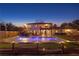 Back of house view at dusk featuring a beautiful pool, patio area, a balcony and a well-kept backyard at 403 Weeburn Rd, Temple Terrace, FL 33617