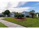 House exterior with a landscaped yard, two-car garage, and a welcoming front entrance at 4726 Windflower Cir, Tampa, FL 33624