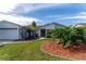 Exterior view of a house featuring attractive landscaping and a teal front door at 4726 Windflower Cir, Tampa, FL 33624
