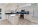 Kitchen boasts granite countertops and blue tile backsplash at 4726 Windflower Cir, Tampa, FL 33624