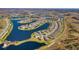 Wide aerial view showcases the community's lakes, winding roads, and numerous homes at 4748 Ballast Crest Cv, Land O Lakes, FL 34638