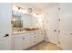 Elegant bathroom with double sinks, stone countertops, and ample cabinet space at 4748 Ballast Crest Cv, Land O Lakes, FL 34638