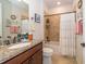 Bathroom boasts a granite counter, decorative wall art, and a tiled shower and tub combination at 4748 Ballast Crest Cv, Land O Lakes, FL 34638