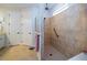 Beautiful walk-in shower with tile surround, glass partition, and accessible features at 4748 Ballast Crest Cv, Land O Lakes, FL 34638