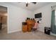 Bedroom area featuring an antique desk, with a large TV mounted on the wall at 4748 Ballast Crest Cv, Land O Lakes, FL 34638