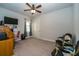 Cozy bedroom featuring neutral walls, plush carpet, and a stylish ceiling fan at 4748 Ballast Crest Cv, Land O Lakes, FL 34638