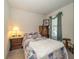 Charming bedroom featuring floral bedding, wood furnishings, and soft lighting at 4748 Ballast Crest Cv, Land O Lakes, FL 34638