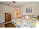 Spacious bedroom with a bed, dresser, and view of an ensuite bathroom at 4748 Ballast Crest Cv, Land O Lakes, FL 34638
