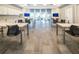 Inviting common room with tables, chairs, and TV, ideal for studying, meetings or socializing with neighbors at 4748 Ballast Crest Cv, Land O Lakes, FL 34638