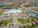 Panoramic aerial view of the community clubhouse, pool, tennis courts, and surrounding landscapes at 4748 Ballast Crest Cv, Land O Lakes, FL 34638