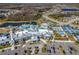 Expansive aerial view of the community clubhouse, pool, parking, and amenity spaces with lush grounds at 4748 Ballast Crest Cv, Land O Lakes, FL 34638