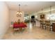 Open concept dining area with a view of the living room and kitchen, featuring a stylish light fixture at 4748 Ballast Crest Cv, Land O Lakes, FL 34638