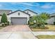 Charming single-story home with a well-manicured lawn, a brick driveway, and a two-car garage in a desirable neighborhood at 4748 Ballast Crest Cv, Land O Lakes, FL 34638