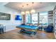 Community game room with pool table and lounging area with views of the pool at 4748 Ballast Crest Cv, Land O Lakes, FL 34638